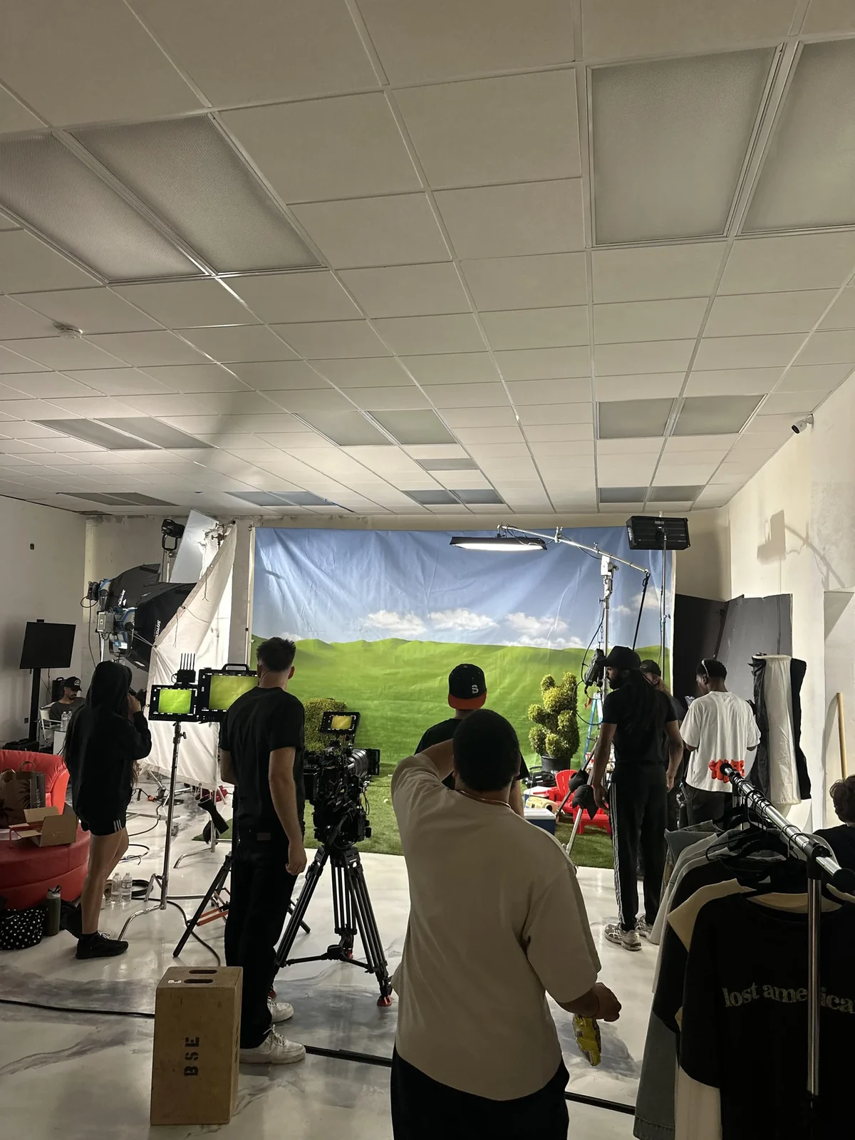 Studio 47 crew setting up an indoor shoot with a projection screen