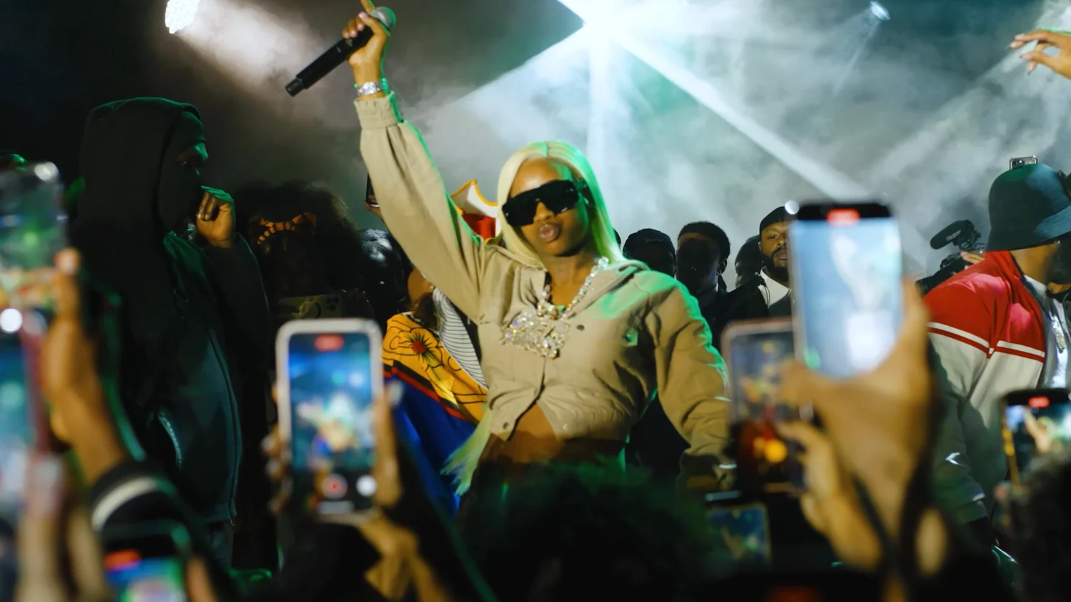 Studio 47 filming a live performance from inside the crowd at night